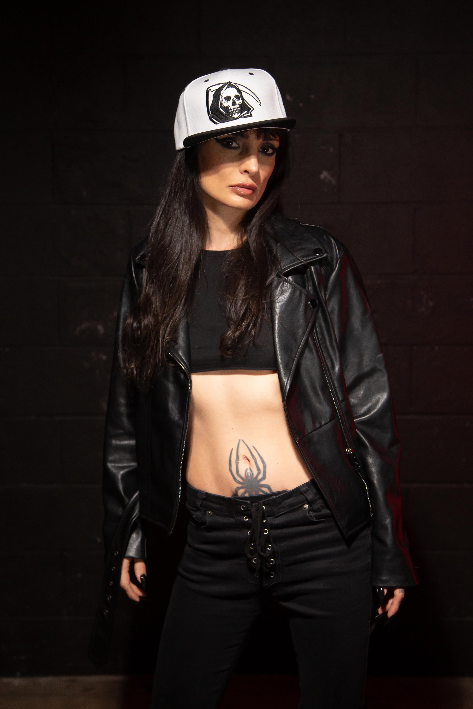 Considered Dead Reaper snapback hat with a white crown, black flat brim, and embroidered graphics.